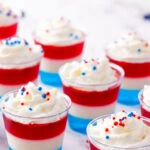 If you’re looking to wow your guests with 4th of July drinks these Patriotic Jello Shots are exactly what your party needs. Layered with vibrant red, white, and blue, these mini treats are the ultimate 4th of July Jello Shots. Whether you’re hosting a backyard BBQ or heading to a fireworks show, these 4th of July cocktails double as dessert and drink in one cute little shot glass. Fourth Of July Cocktails, Summer Jello Shot Recipes, Patriotic Food, Patriotic Jello Shots, 4Th Of July Drinks Alcoholic, 4Th Of July Jello Desserts, Fun Jello Shots, 4Th Of July Party Ideas, Fourth Of July Jello Shots